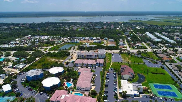 an aerial view of residential houses with outdoor space