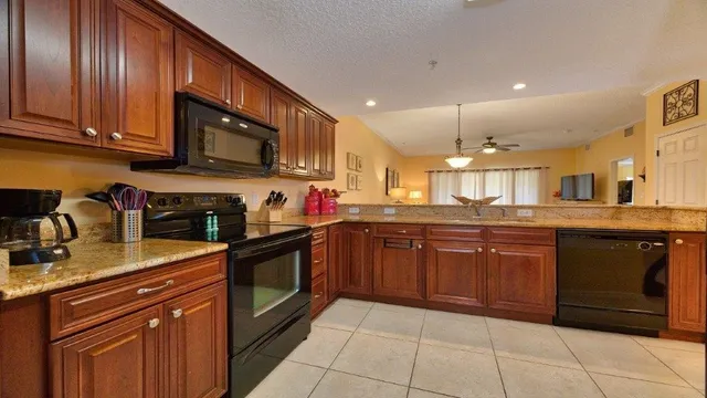 a kitchen with stainless steel appliances granite countertop wooden cabinets a sink and dishwasher