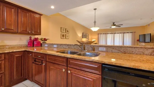a kitchen with stainless steel appliances granite countertop a sink stove and cabinets