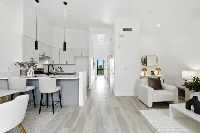 a living room with kitchen island furniture and a wooden floor