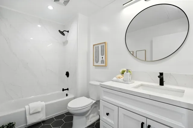 a bathroom with a sink toilet and a mirror