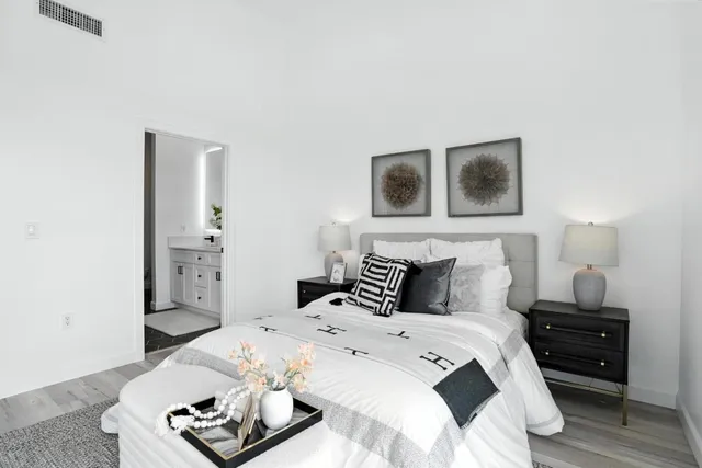 a bedroom with a bed and a night stand