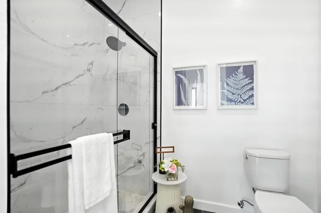 a bathroom with a sink toilet and shower