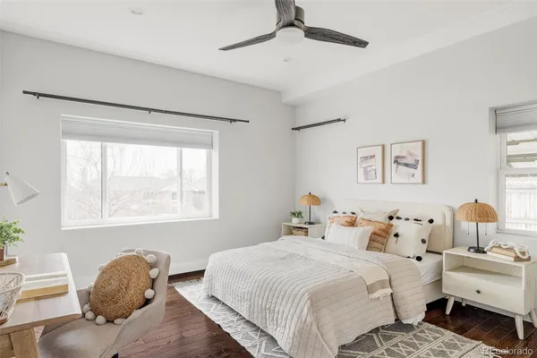 a bedroom with a bed and a lamp on the dresser