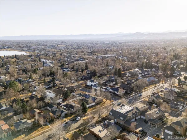 an aerial view of residential houses with city view