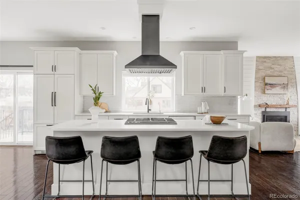 a kitchen with a stove a sink and a refrigerator