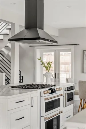 a kitchen with sink stove and refrigerator