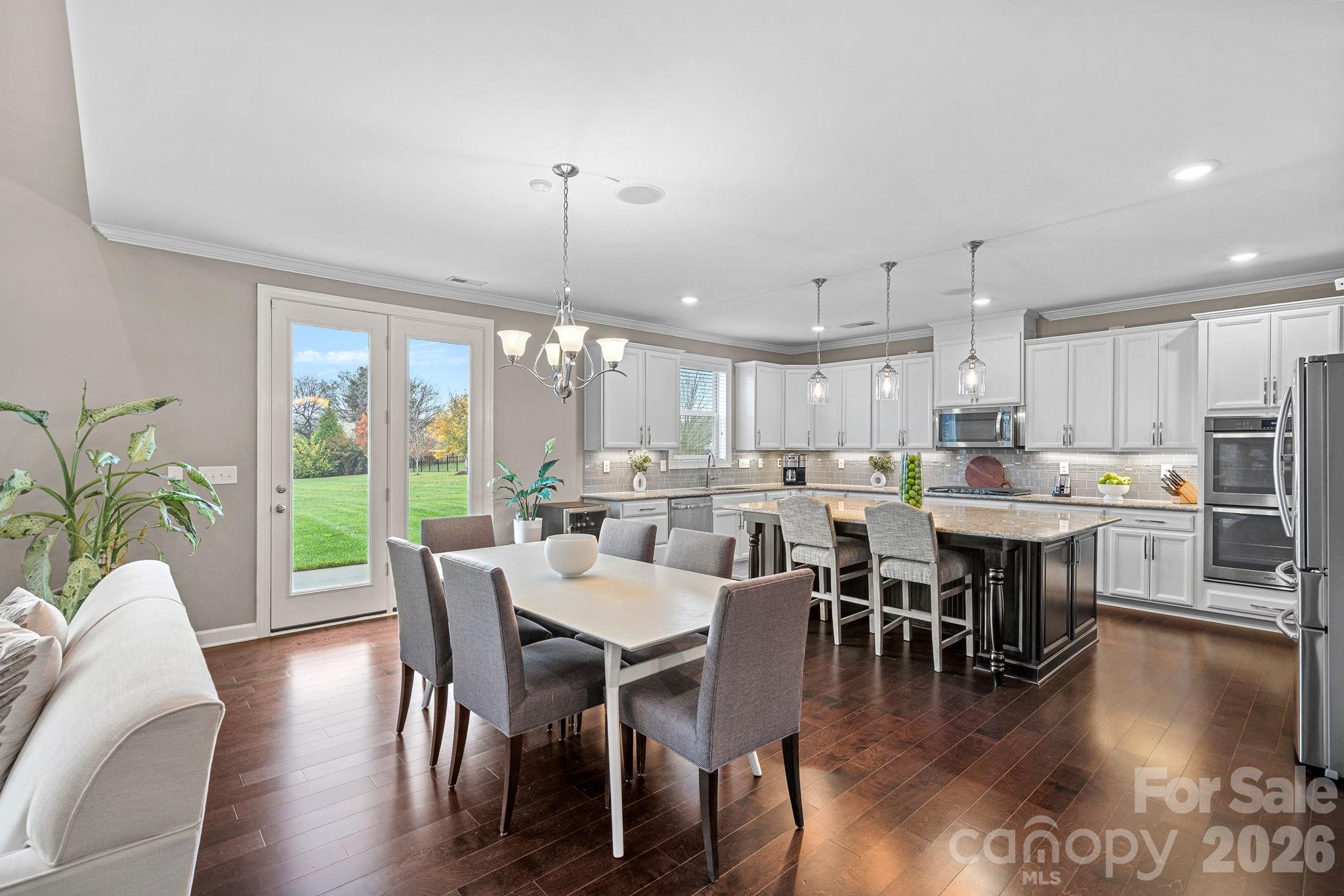 706 Blaise Court Matthews, NC 28104 - Photo 12 of 48 a view of a dining room with furniture window and wooden floor