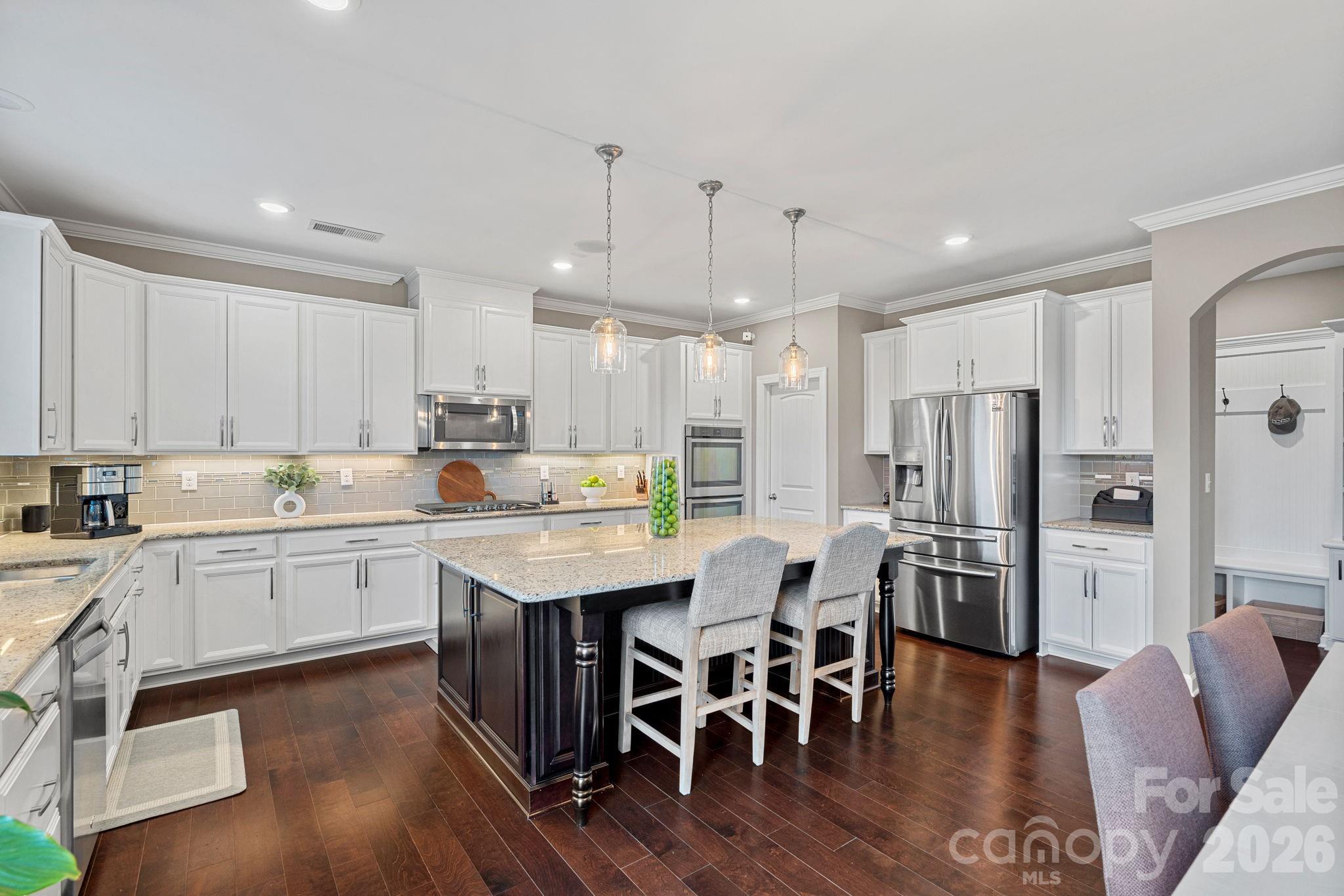 706 Blaise Court Matthews, NC 28104 - Photo 13 of 48 a kitchen with stainless steel appliances kitchen island granite countertop a kitchen island hardwood floor and a sink