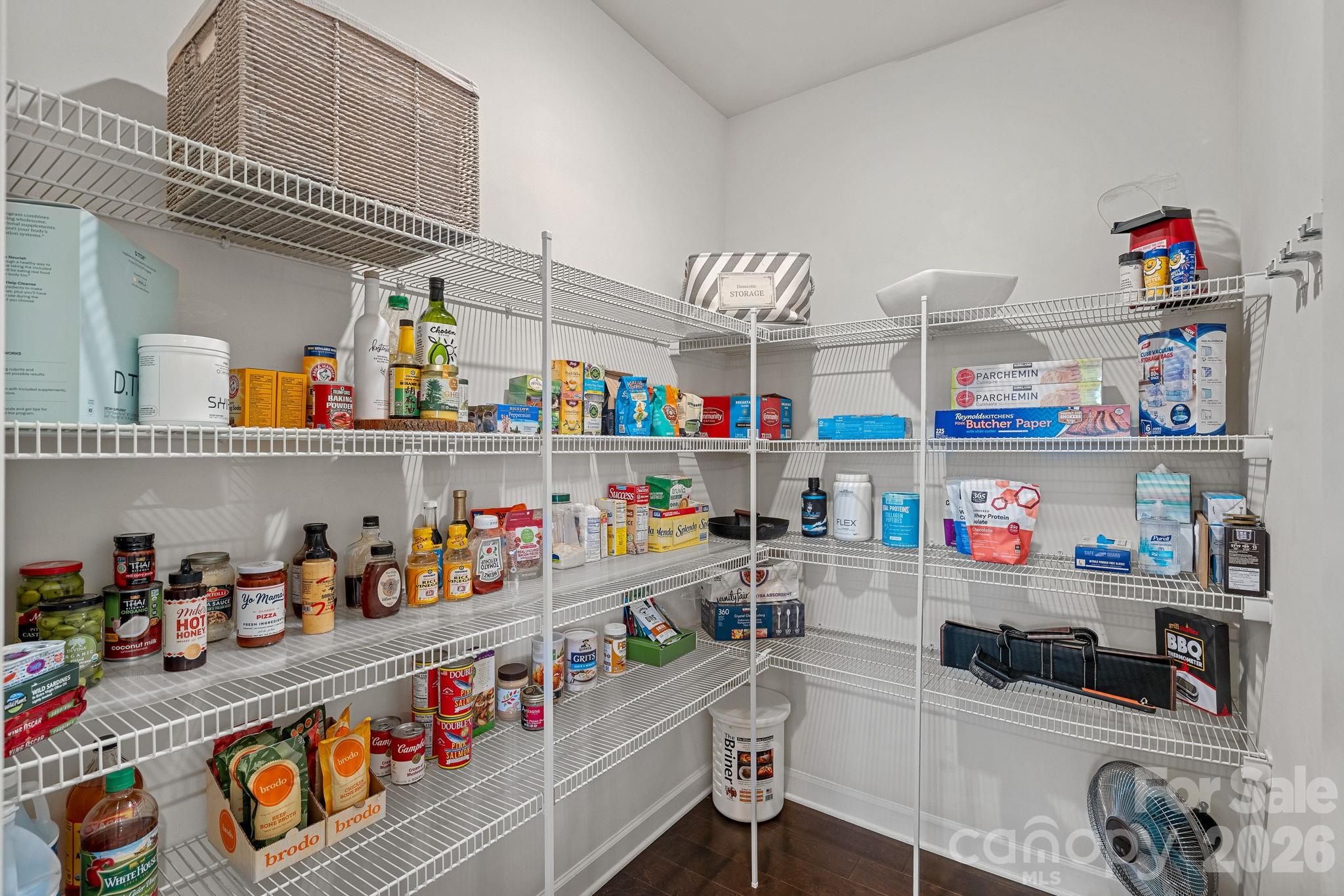 706 Blaise Court Matthews, NC 28104 - Photo 18 of 48 a room with stainless steel appliances a white wooden floor and a shelf