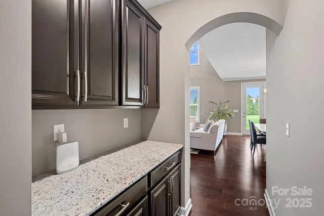 a view of a kitchen area with furniture and wooden floor
