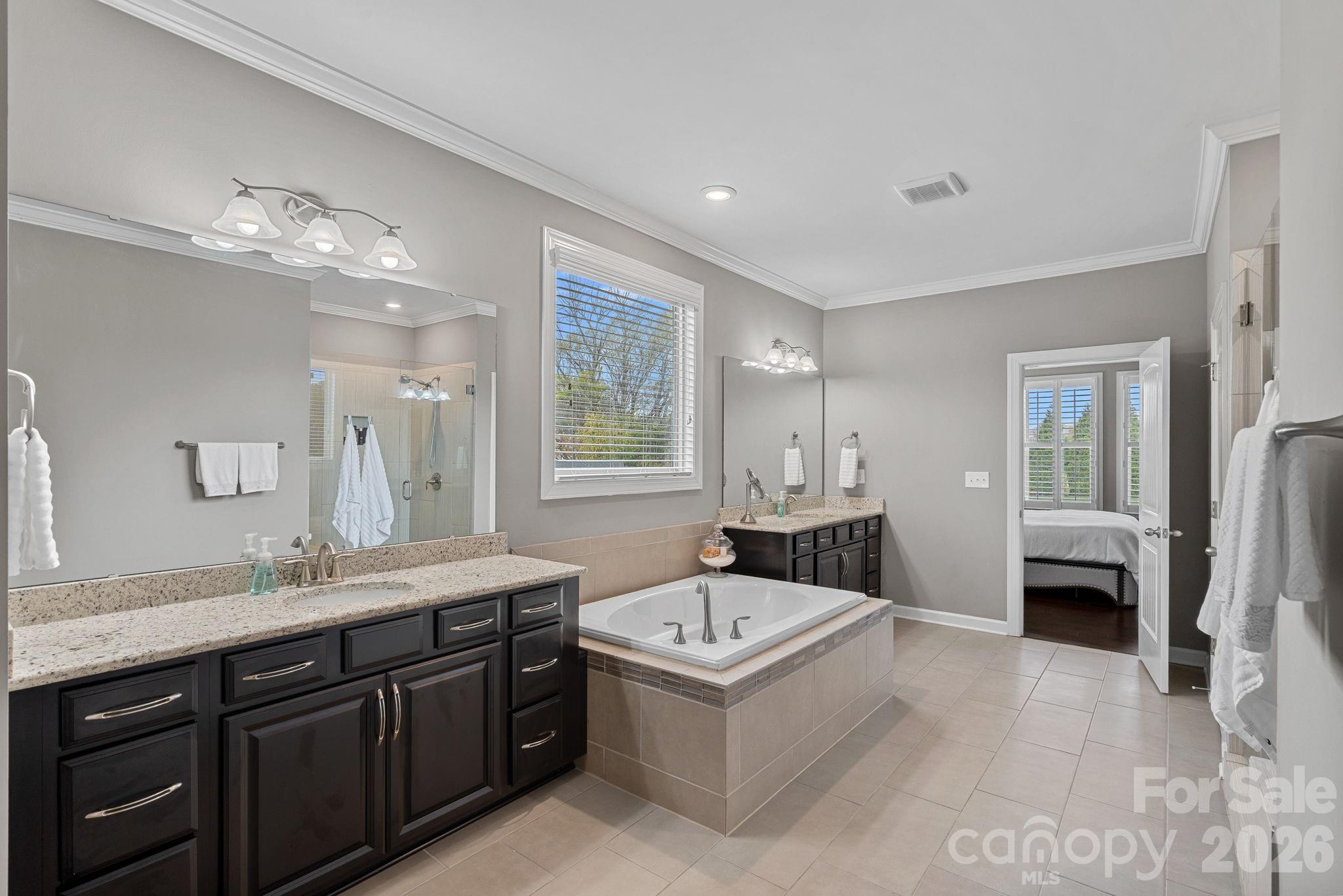706 Blaise Court Matthews, NC 28104 - Photo 25 of 48 a spacious bathroom with a tub double sink and mirrors