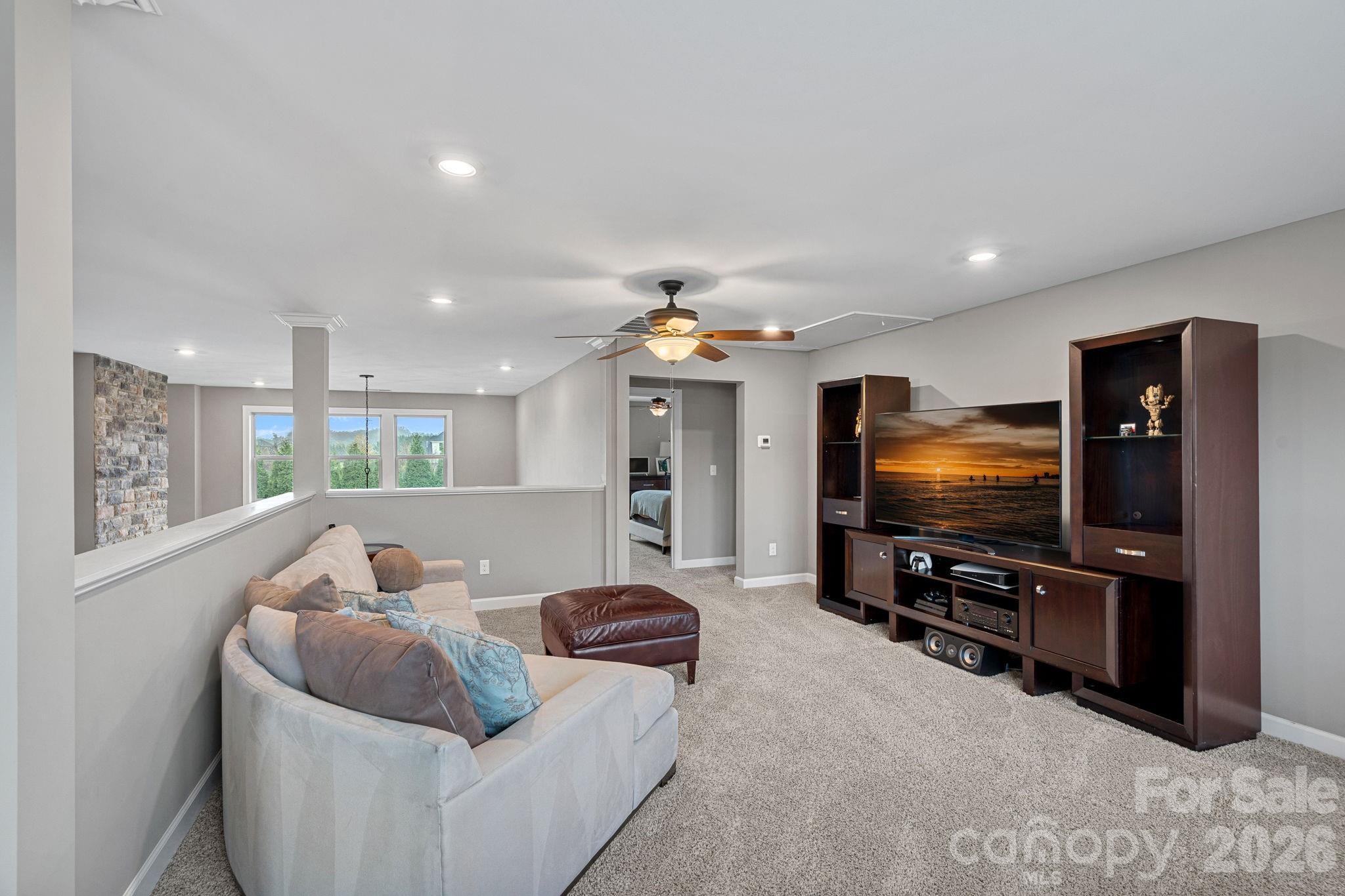 706 Blaise Court Matthews, NC 28104 - Photo 29 of 48 a living room with furniture and a flat screen tv