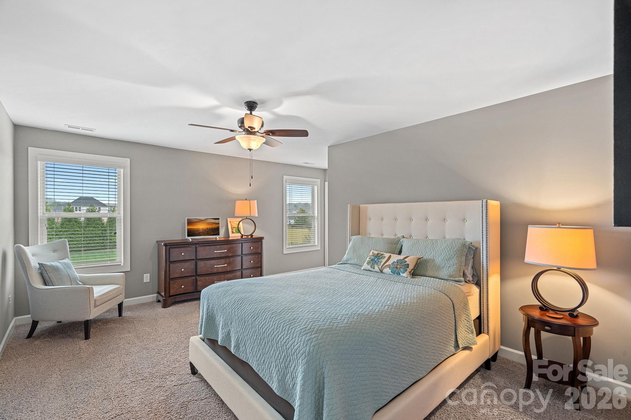 706 Blaise Court Matthews, NC 28104 - Photo 36 of 48 a bedroom with a bed and a chandelier