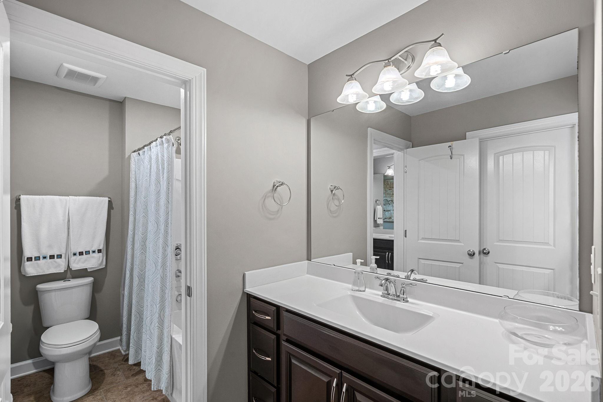706 Blaise Court Matthews, NC 28104 - Photo 38 of 48 a bathroom with a sink a toilet and a mirror