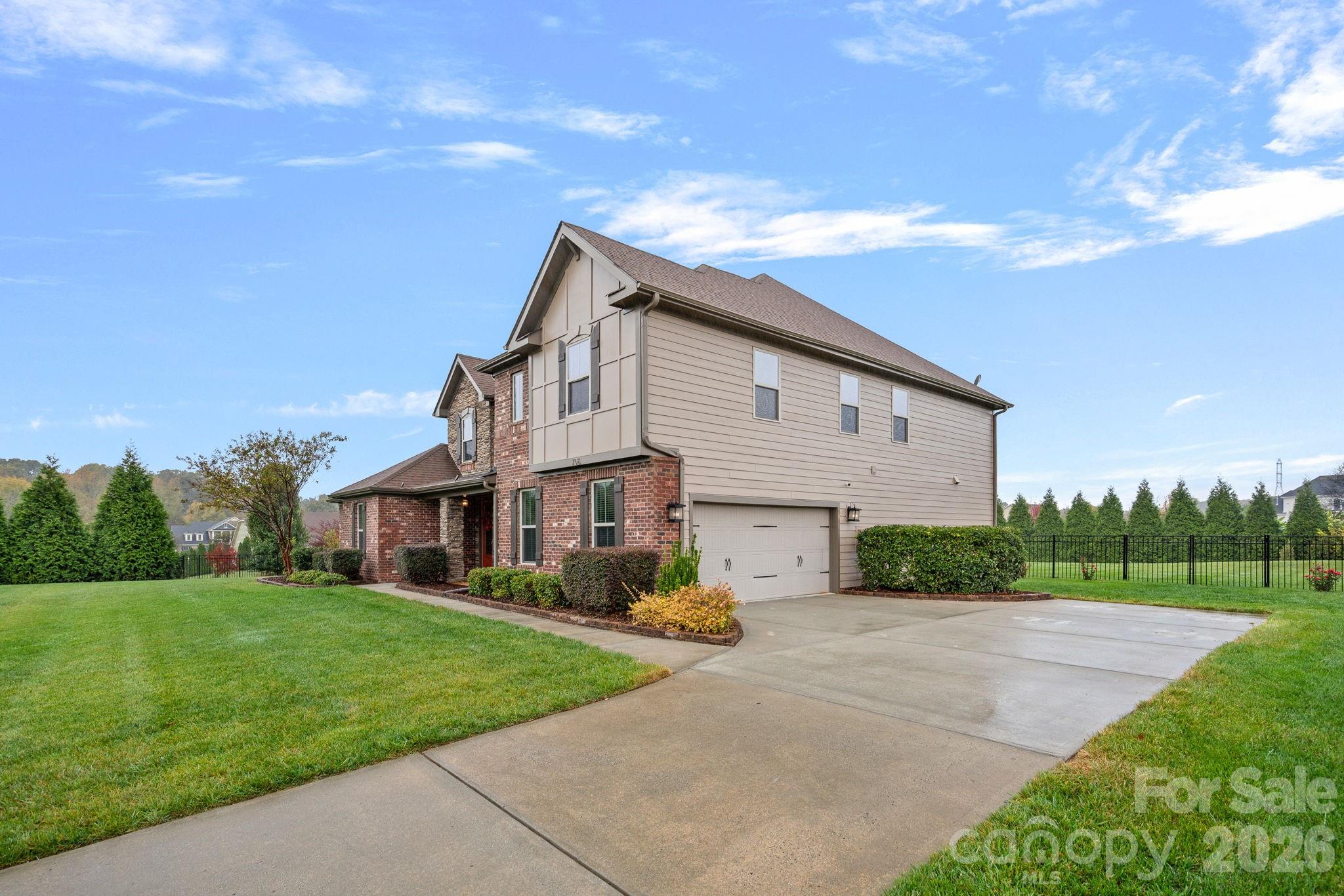 706 Blaise Court Matthews, NC 28104 - Photo 41 of 48 a view of a white house next to a yard with big trees