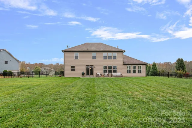a front view of a house with a yard and trees