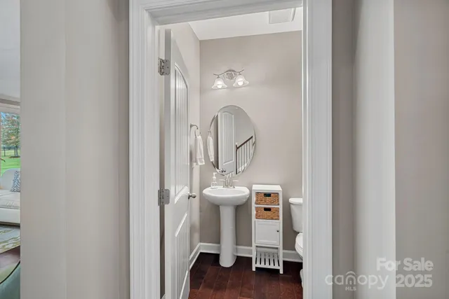 a close view of a bathroom sink with wooden floor