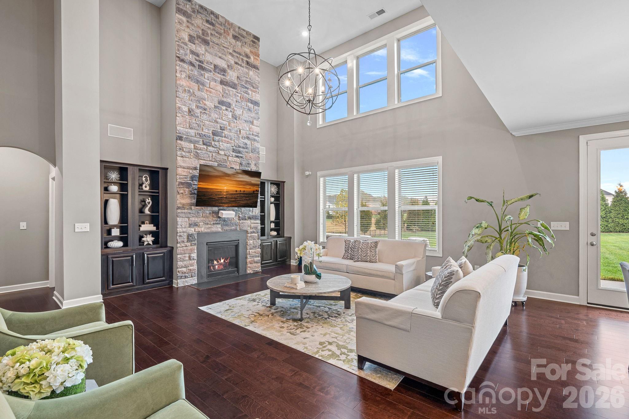 706 Blaise Court Matthews, NC 28104 - Photo 10 of 48 a living room with fireplace furniture and a flat screen tv