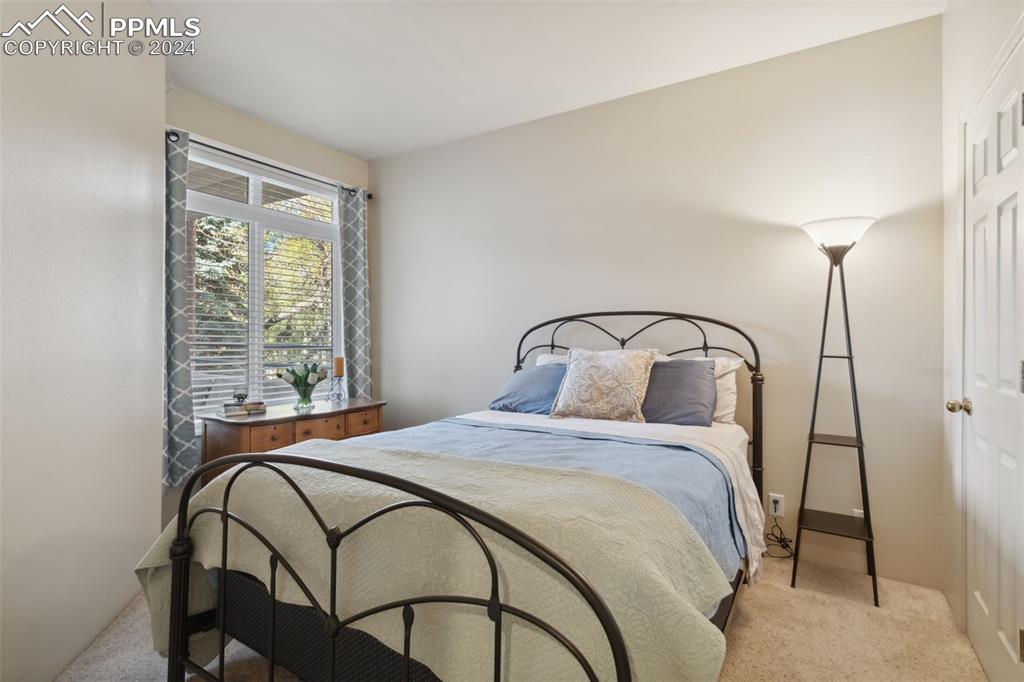 175 West Cheyenne Road, Unit 214 Colorado Springs, CO 80906 - Photo 14 of 28 a bedroom with a bed and a mirror