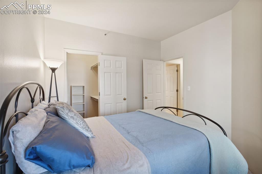 175 West Cheyenne Road, Unit 214 Colorado Springs, CO 80906 - Photo 15 of 28 a bedroom with a bed and a large mirror