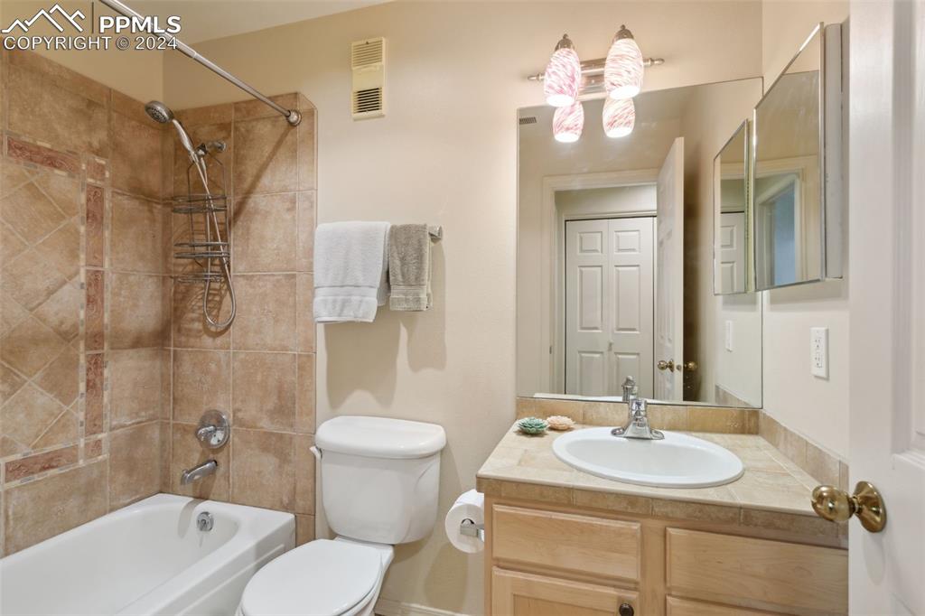 175 West Cheyenne Road, Unit 214 Colorado Springs, CO 80906 - Photo 16 of 28 a bathroom with a sink toilet a mirror and shower