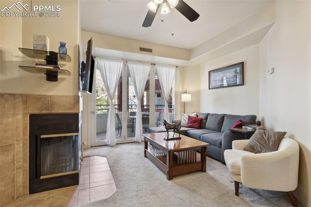 175 West Cheyenne Road, Unit 214 Colorado Springs, CO 80906 - Photo 4 of 28 a living room with furniture and a fireplace