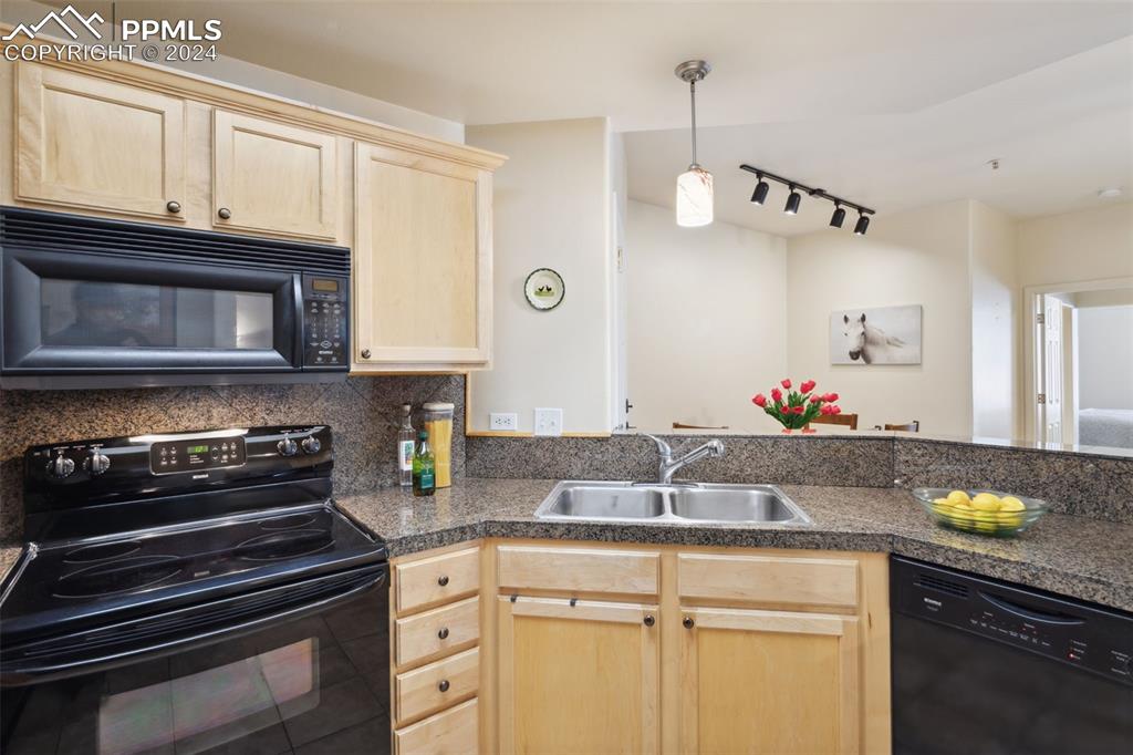 175 West Cheyenne Road, Unit 214 Colorado Springs, CO 80906 - Photo 6 of 28 a kitchen with stainless steel appliances granite countertop a sink and cabinets