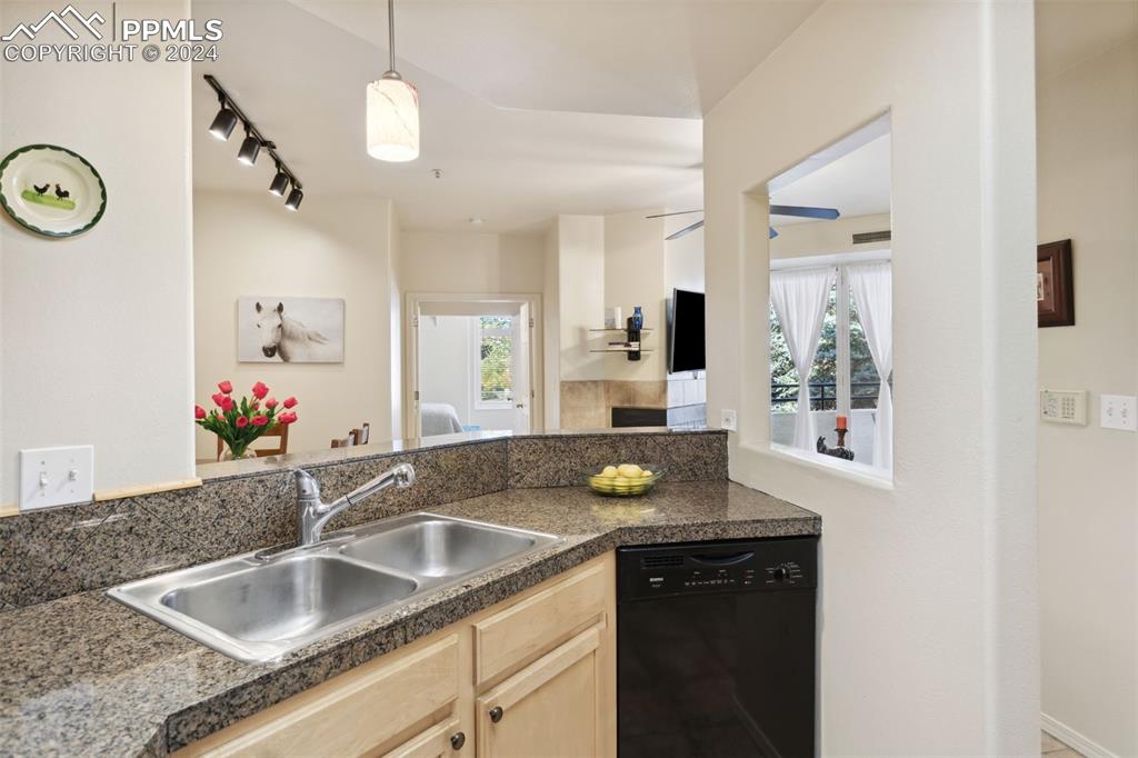 175 West Cheyenne Road, Unit 214 Colorado Springs, CO 80906 - Photo 7 of 28 a kitchen with a sink and a refrigerator