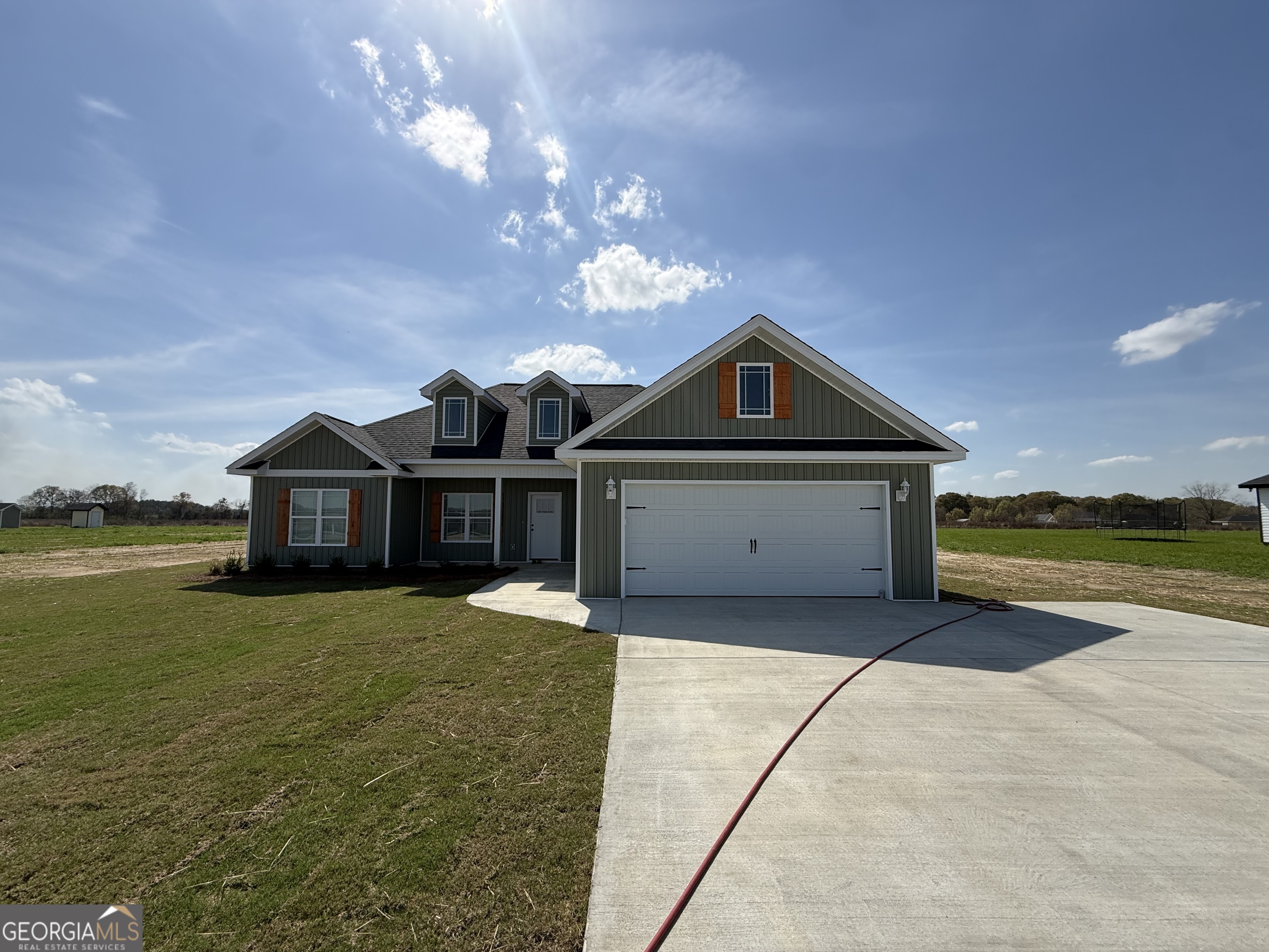 1265 Mark Wood Road Dexter, GA 31019 - Photo 1 of 1 a front view of a house with a yard and lake view
