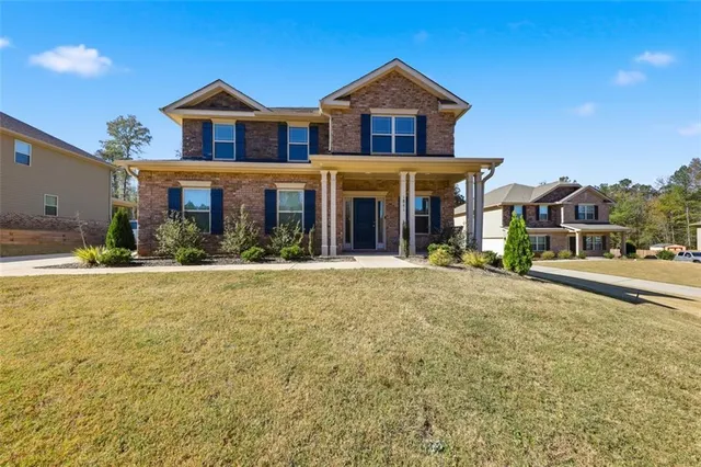 a front view of a house with a yard