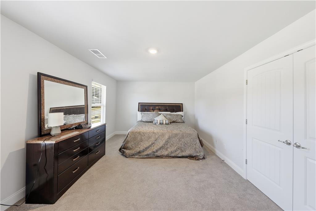 1861 Abbey Road Griffin, GA 30223 - Photo 15 of 26 a bedroom with a bed and a large window