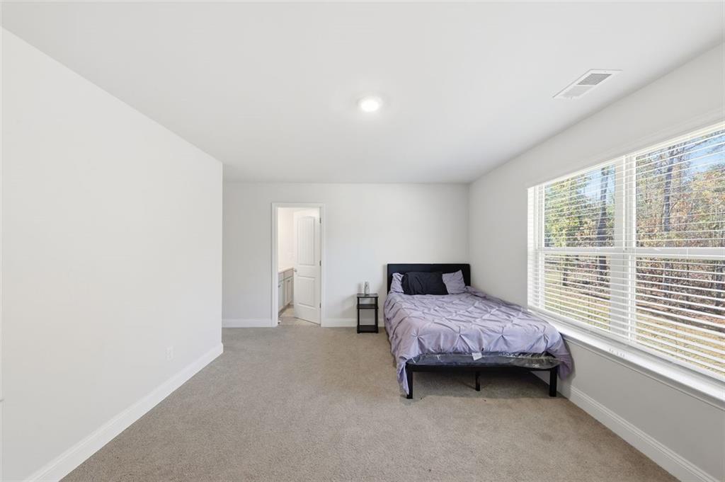 1861 Abbey Road Griffin, GA 30223 - Photo 16 of 26 a bedroom with a bed and a window