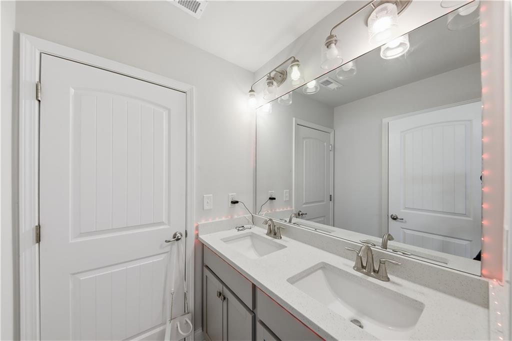 1861 Abbey Road Griffin, GA 30223 - Photo 17 of 26 a bathroom with a sink and a mirror