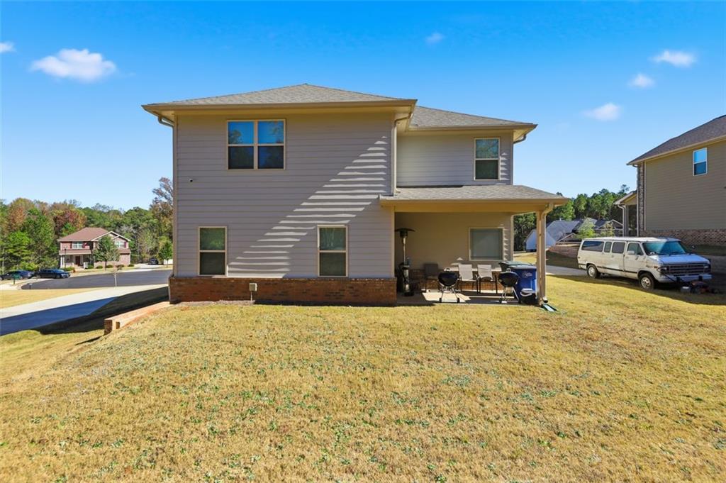 1861 Abbey Road Griffin, GA 30223 - Photo 22 of 26 a view of a house with patio and a yard