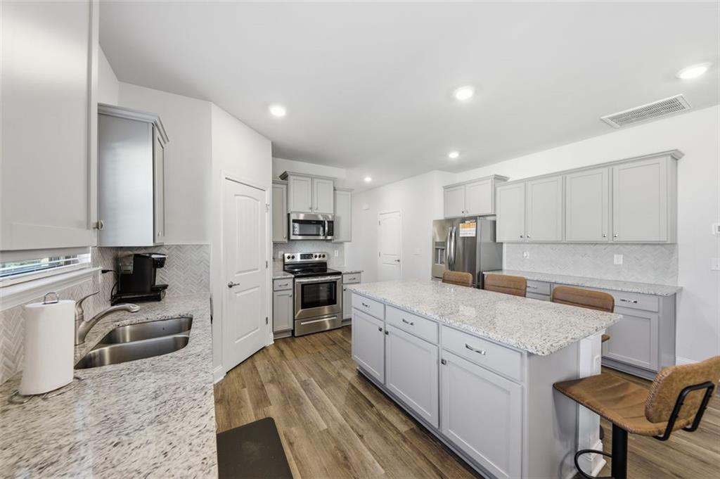 1861 Abbey Road Griffin, GA 30223 - Photo 3 of 26 a kitchen with white cabinets and appliances