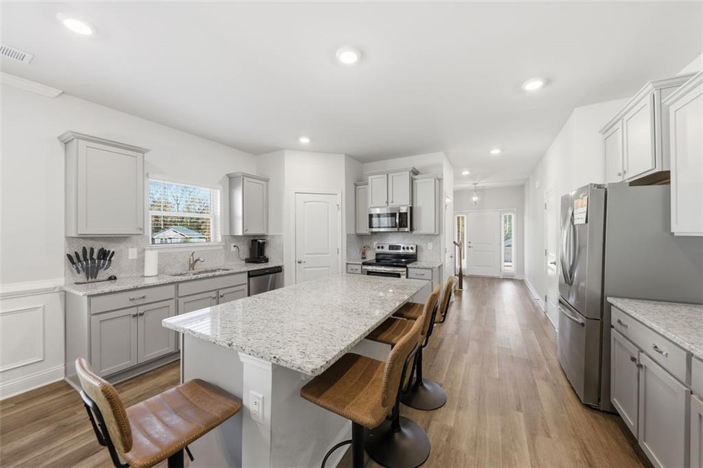 1861 Abbey Road Griffin, GA 30223 - Photo 4 of 26 a large kitchen with a table and chairs