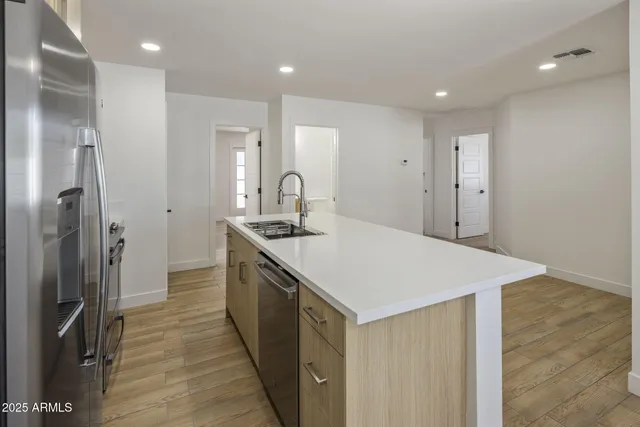a kitchen with a sink and refrigerator