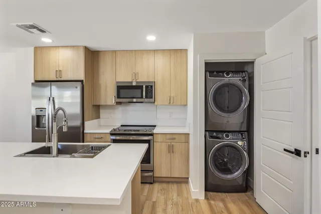 a kitchen with sink a washer and dryer