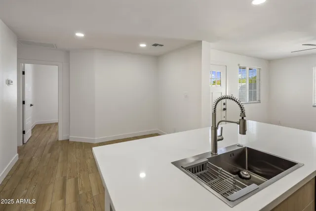 a kitchen with a sink and a stove top oven