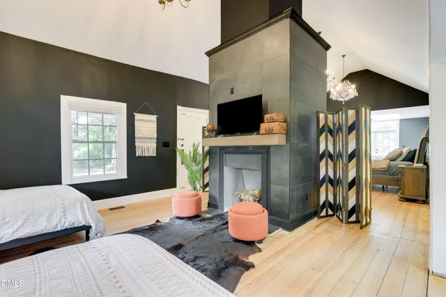 a bedroom with two beds and a flat screen tv