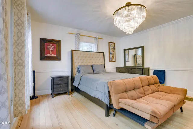 a bedroom with furniture and a large window