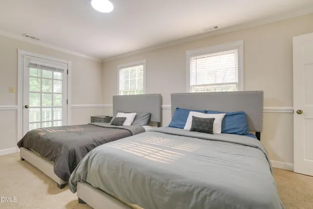 a bedroom with two beds and a window