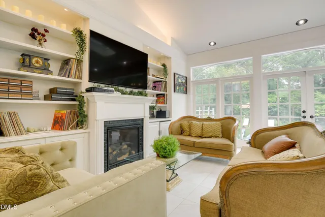 a living room with furniture fireplace and flat screen tv
