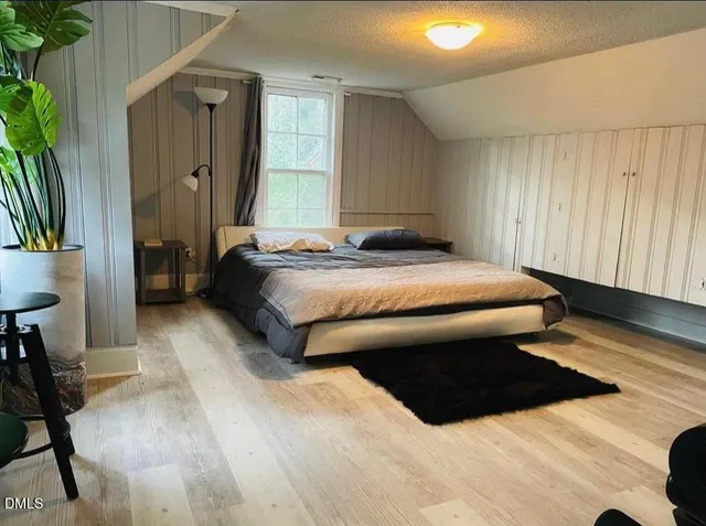a spacious bedroom with a bed and a table in it