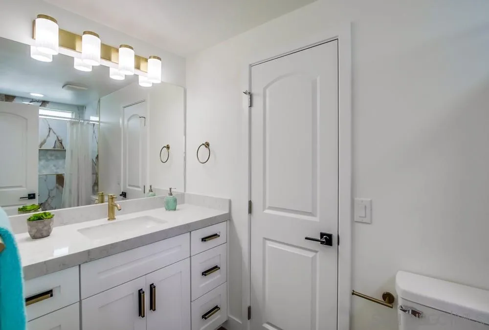 1120 Pepper Drive, Unit 78 El Cajon, CA 92021 - Photo 13 of 16 a bathroom with a sink a light fixture and a mirror