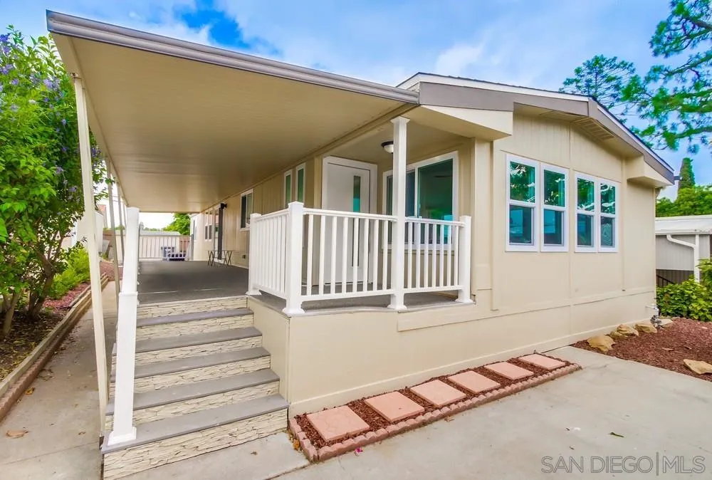 1120 Pepper Drive, Unit 78 El Cajon, CA 92021 - Photo 2 of 16 a view of a house with a small yard and wooden floor and fence
