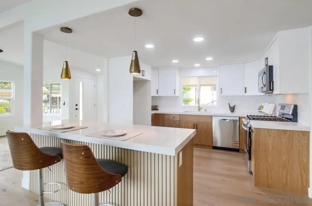 1120 Pepper Drive, Unit 78 El Cajon, CA 92021 - Photo 6 of 16 a kitchen with granite countertop white cabinets and stainless steel appliances