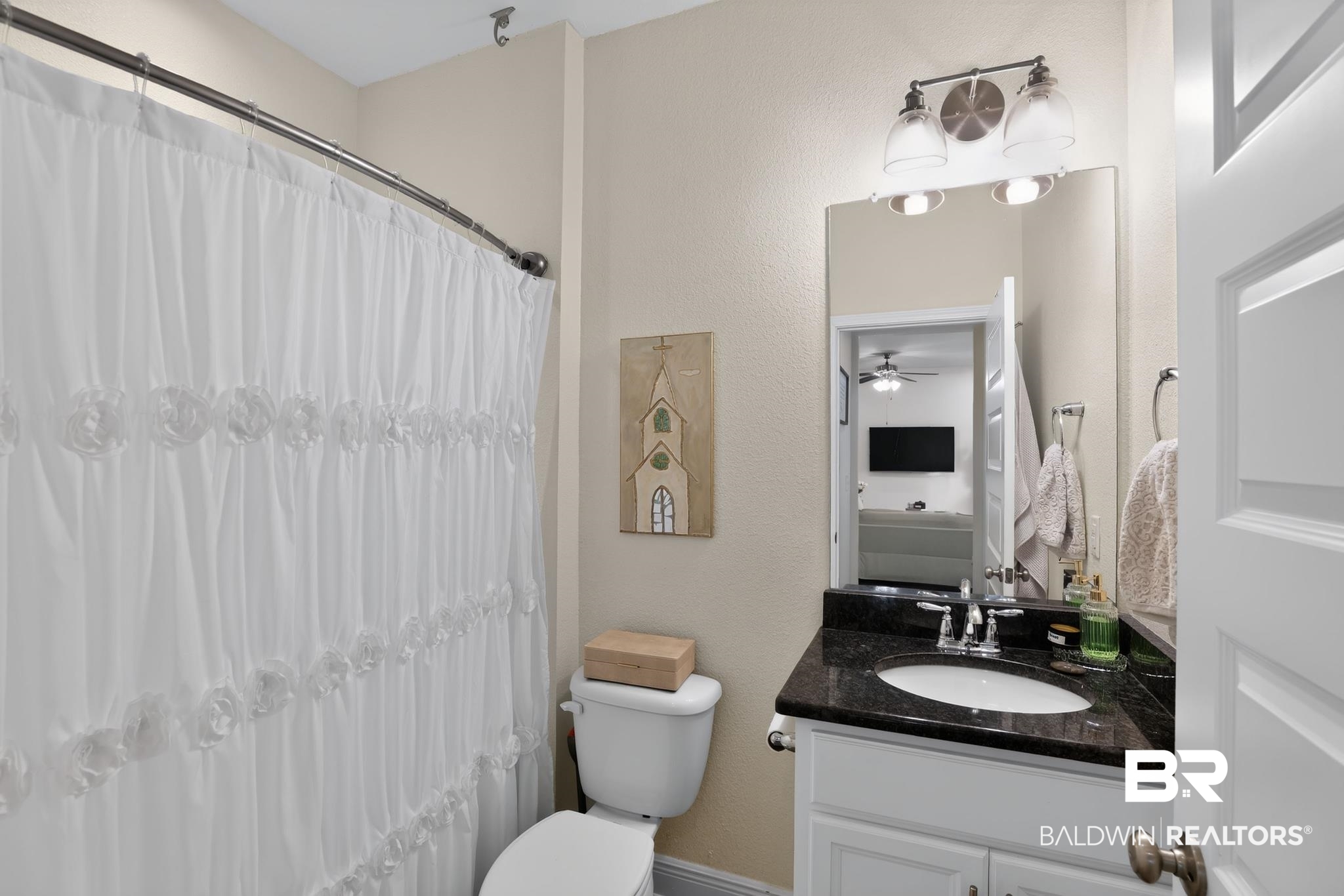 1210 Primrose Lane Foley, AL 36535 - Photo 23 of 33 Bathroom featuring a white vanity with dark countertop, a wall-mounted mirror, and a two-light fixture