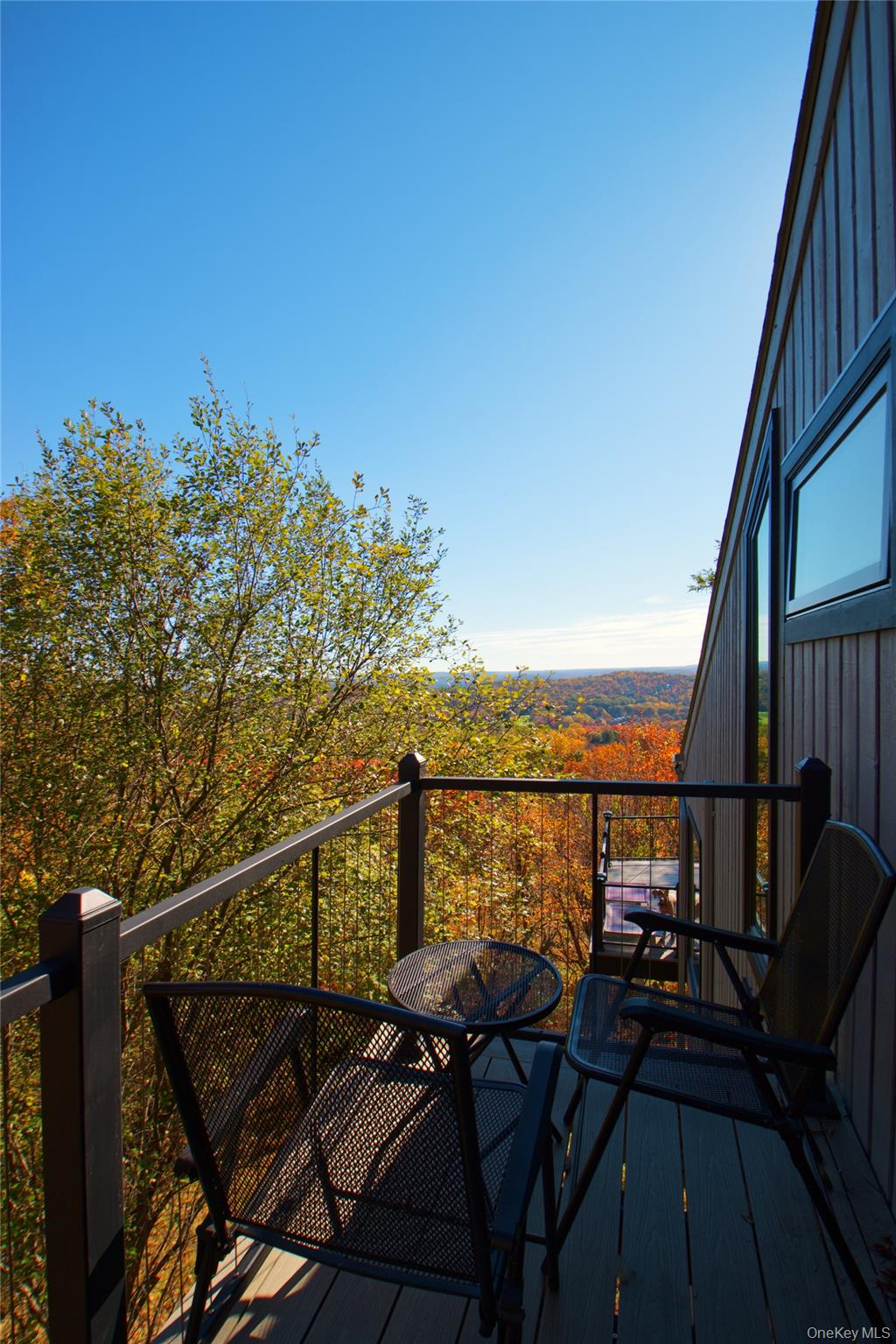 26 Summit Cir Drive Mahopac, NY 10541 - Photo 19 of 32 a view of a balcony with wooden chairs and floor